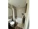 Well-lit bathroom featuring a shower-tub combo, modern tile, and neutral color palette at 10470 Sw 132Nd Ct, Dunnellon, FL 34432
