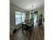 A dining area with seating for four, view of the backyard through a sliding glass door at 10470 Sw 132Nd Ct, Dunnellon, FL 34432