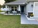 Inviting porch, with seating, enhanced by decorative plants and stylish accents at 10470 Sw 132Nd Ct, Dunnellon, FL 34432