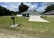 Charming home featuring a well-manicured lawn, a two-car garage and mailbox at 10470 Sw 132Nd Ct, Dunnellon, FL 34432