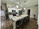 Kitchen with an island, granite countertops, stainless steel appliances and white cabinetry at 10470 Sw 132Nd Ct, Dunnellon, FL 34432