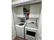 A laundry room with white cabinets above the washer and dryer units at 10470 Sw 132Nd Ct, Dunnellon, FL 34432