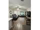 View of the living room featuring wood floors, a large leather sofa, and a ceiling fan at 10470 Sw 132Nd Ct, Dunnellon, FL 34432