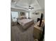 Main bedroom features a tray ceiling, carpeted floors, and a large bed at 10470 Sw 132Nd Ct, Dunnellon, FL 34432