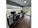 Well-lit home office with large windows and a sliding door to the outside at 10470 Sw 132Nd Ct, Dunnellon, FL 34432