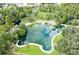 A serene aerial view of the natural springs and surrounding lush greenery, offering a tranquil escape at 211 Crown Oaks Way, Longwood, FL 32779