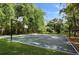Outdoor basketball court surrounded by trees, offering a fun and active recreational area at 211 Crown Oaks Way, Longwood, FL 32779
