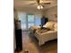 Bright bedroom with white curtains, a comfortable bed, and brick accent wall at 211 Crown Oaks Way, Longwood, FL 32779