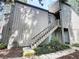 Two-story townhouse with wood siding and stairs leading to the front door at 211 Crown Oaks Way, Longwood, FL 32779