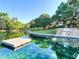 Scenic community pond with a dock, clear water, and surrounding lush green landscape offering residents tranquility at 211 Crown Oaks Way, Longwood, FL 32779