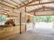 Well-maintained horse stables featuring wooden stalls and ample space for the animals to move around comfortably at 211 Crown Oaks Way, Longwood, FL 32779