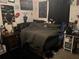 Dark bedroom with personalized wall decor and a comfortable bed perfect for a teenager at 31517 Broadwater Ave, Leesburg, FL 34748