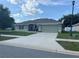 Charming single-story home featuring a well-maintained lawn, two-car garage, and inviting front entrance at 31517 Broadwater Ave, Leesburg, FL 34748