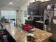 Well-equipped kitchen features dark wood cabinets and an extended granite countertop with a breakfast bar at 31517 Broadwater Ave, Leesburg, FL 34748