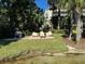 Backyard lounge seating on a grassy area with view of the water and nearby condos at 690 Osceola Ave # 405, Winter Park, FL 32789