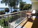Balcony view overlooks pool and lush landscaping with lake views beyond at 690 Osceola Ave # 405, Winter Park, FL 32789