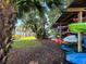 Kayak and boat storage in a covered wooden rack near the beach and palm trees at 690 Osceola Ave # 405, Winter Park, FL 32789