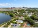 Aerial view of a home featuring a private pool, patio and waterfront with city views at 1410 Poinsettia Ave, Orlando, FL 32804
