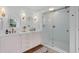 Bright bathroom with double vanity, and a glass-enclosed shower with gold hardware at 1410 Poinsettia Ave, Orlando, FL 32804