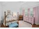 Charming bedroom featuring a four-poster bed, pink accents, and lots of natural light at 1410 Poinsettia Ave, Orlando, FL 32804