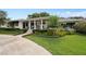 Charming home featuring a landscaped front yard, covered porch and a circular driveway at 1410 Poinsettia Ave, Orlando, FL 32804