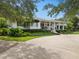 Charming home featuring a landscaped front yard, covered porch and a circular driveway at 1410 Poinsettia Ave, Orlando, FL 32804