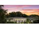 Charming home featuring a landscaped front yard, covered porch and a circular driveway at 1410 Poinsettia Ave, Orlando, FL 32804