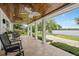 Covered porch with a wood ceiling and outdoor seating overlooking the lake at 1410 Poinsettia Ave, Orlando, FL 32804
