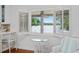 Stunning water view from the breakfast nook, with white shutters and matching furniture at 1410 Poinsettia Ave, Orlando, FL 32804