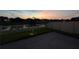 Paver patio with string lights illuminating the seating area and fenced backyard at dusk at 1896 Napoli Dr, St Cloud, FL 34771