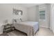 This bedroom features a patterned duvet and wood look floors with decorative art at 1896 Napoli Dr, St Cloud, FL 34771