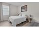 Bedroom features natural light, simple decor, wood-look floors and gray accents at 1896 Napoli Dr, St Cloud, FL 34771