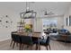 Open-concept living and dining area featuring modern lighting and neutral color palette at 1896 Napoli Dr, St Cloud, FL 34771