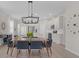 Bright dining area with modern chandelier, wood-look floors, and open access to the kitchen at 1896 Napoli Dr, St Cloud, FL 34771