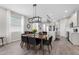 Dining area with bright natural light and hardwood floors opens to kitchen at 1896 Napoli Dr, St Cloud, FL 34771