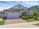 Beautiful home featuring a brick driveway and a well-maintained front yard with lush landscaping at 1896 Napoli Dr, St Cloud, FL 34771