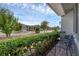 Relaxing front porch with seating area and view of the street with lush landscaping at 1896 Napoli Dr, St Cloud, FL 34771