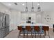 Modern kitchen with white cabinets, quartz countertops, island with seating, and stainless appliances at 1896 Napoli Dr, St Cloud, FL 34771