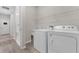 Bright laundry room with a utility sink features newer washer and dryer and built-in storage at 1896 Napoli Dr, St Cloud, FL 34771
