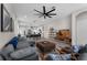 Open-concept living area with hardwood floors, modern lighting and view to kitchen at 1896 Napoli Dr, St Cloud, FL 34771