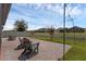 Paver patio with outdoor seating, string lights and fenced backyard with views of the landscaping at 1896 Napoli Dr, St Cloud, FL 34771