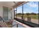 Screened patio featuring brick floor, ceiling fan, sliding glass doors, and comfortable seating with views of the fenced backyard at 1896 Napoli Dr, St Cloud, FL 34771
