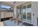 Covered patio features seating, brick flooring, and a screened-in lanai for outdoor enjoyment at 1896 Napoli Dr, St Cloud, FL 34771