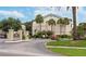 Community entrance sign with lush landscaping and a winding driveway at 1948 Lake Atriums Cir # 132, Orlando, FL 32839