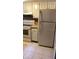 Kitchen with tiled flooring, white appliances, and neutral countertops at 1948 Lake Atriums Cir # 132, Orlando, FL 32839