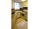 Cozy kitchen with tiled countertops and flooring and white appliances at 1948 Lake Atriums Cir # 132, Orlando, FL 32839