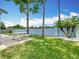 Landscaped backyard features a white picnic table, new grass, and palm trees, perfect for outdoor dining and relaxing at 2641 Delcrest Dr, Orlando, FL 32817