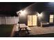 The patio has a sliding glass door into the house, a picnic table and a bench for additional seating at 2641 Delcrest Dr, Orlando, FL 32817
