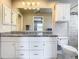 Charming bathroom features granite countertops, white cabinetry, and tile shower at 2641 Delcrest Dr, Orlando, FL 32817