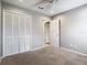 Bedroom with neutral carpet, louvered closet doors, door to hallway and neutral walls at 2641 Delcrest Dr, Orlando, FL 32817